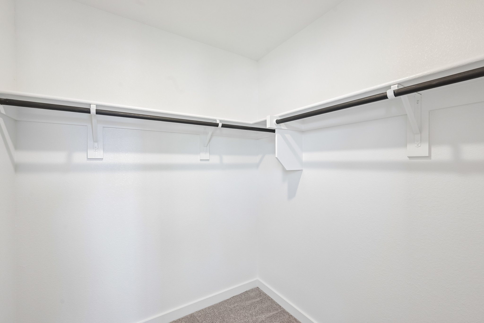 A white wall with a metal railing.