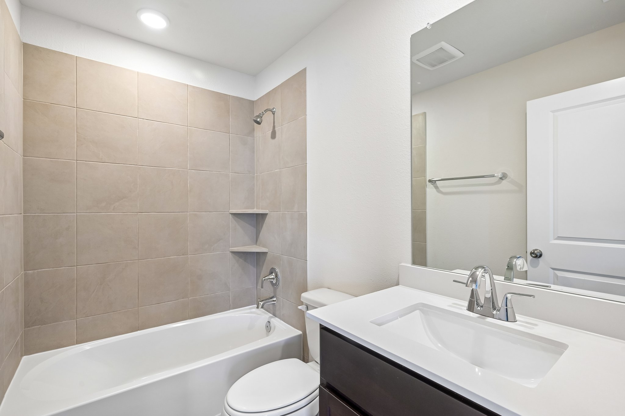 A bathroom with a tub sink and toilet.