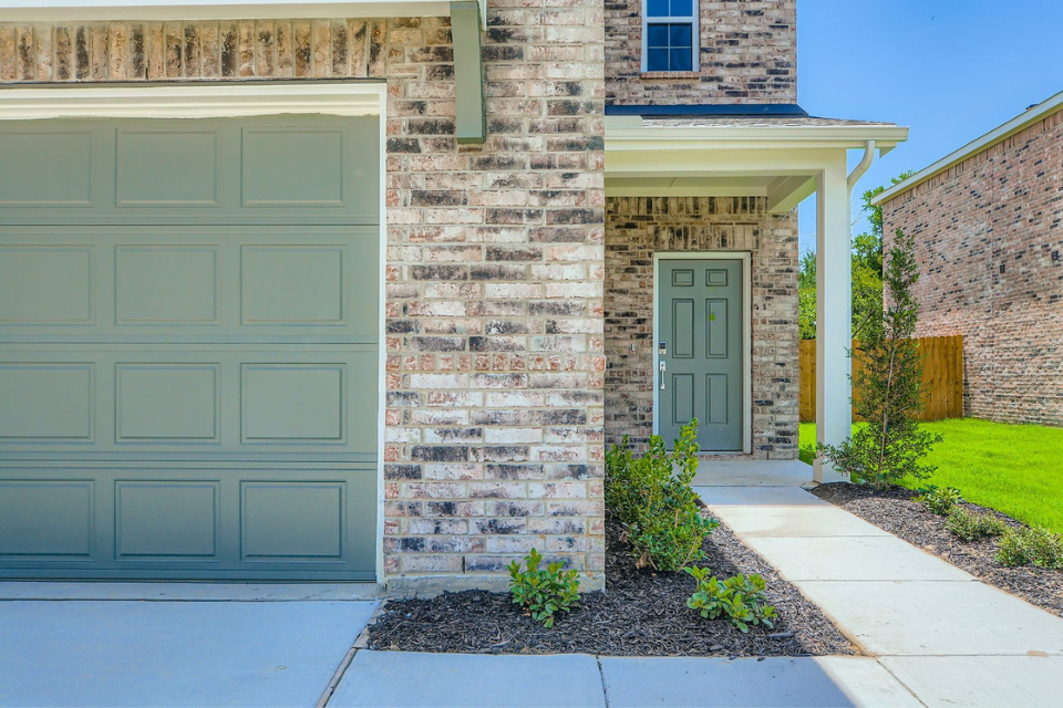 A stone building with a green door.
