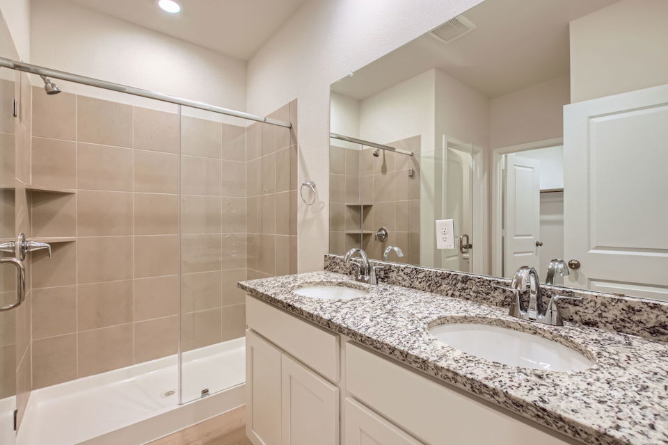 A bathroom with a large mirror.