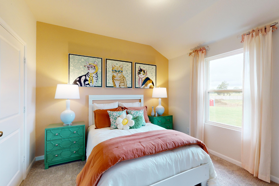 A bedroom with a bed and lamps.