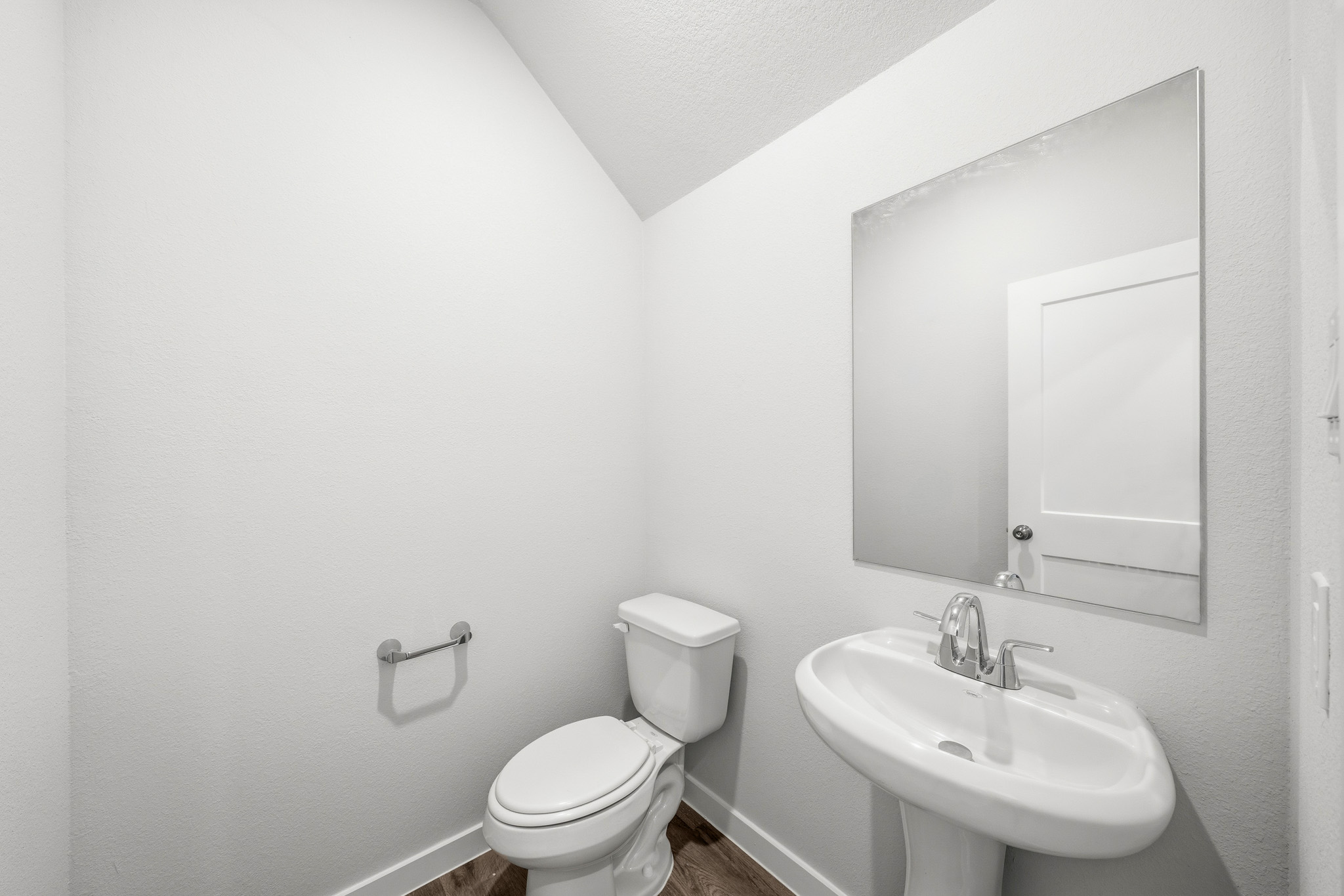 A bathroom with a toilet and sink.