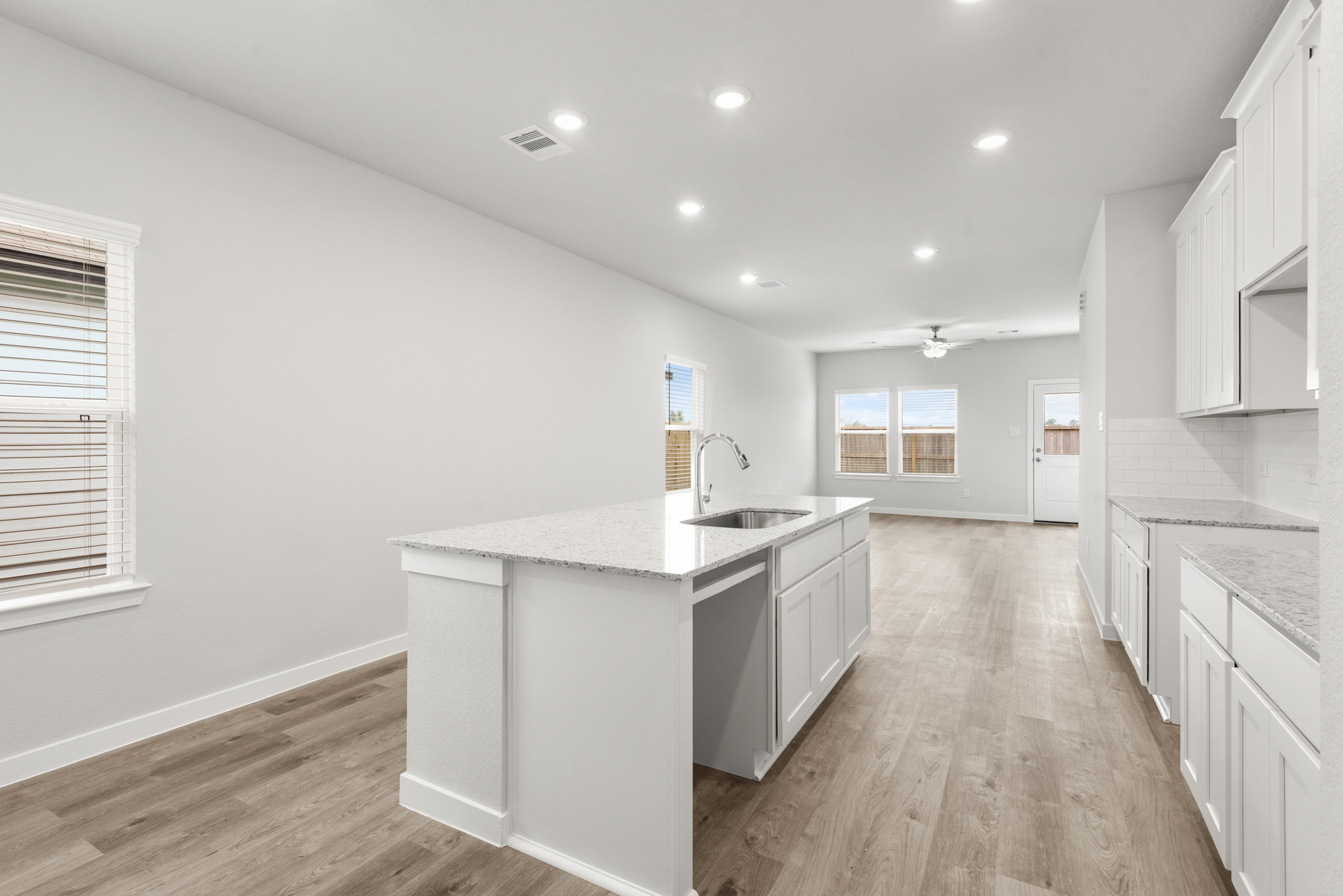 A kitchen with white cabinets.