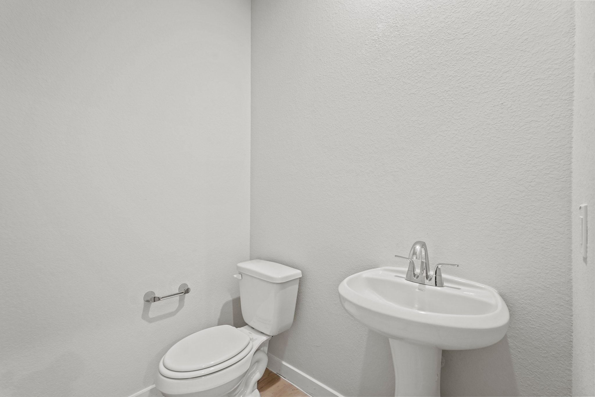 A bathroom with a toilet and sink.