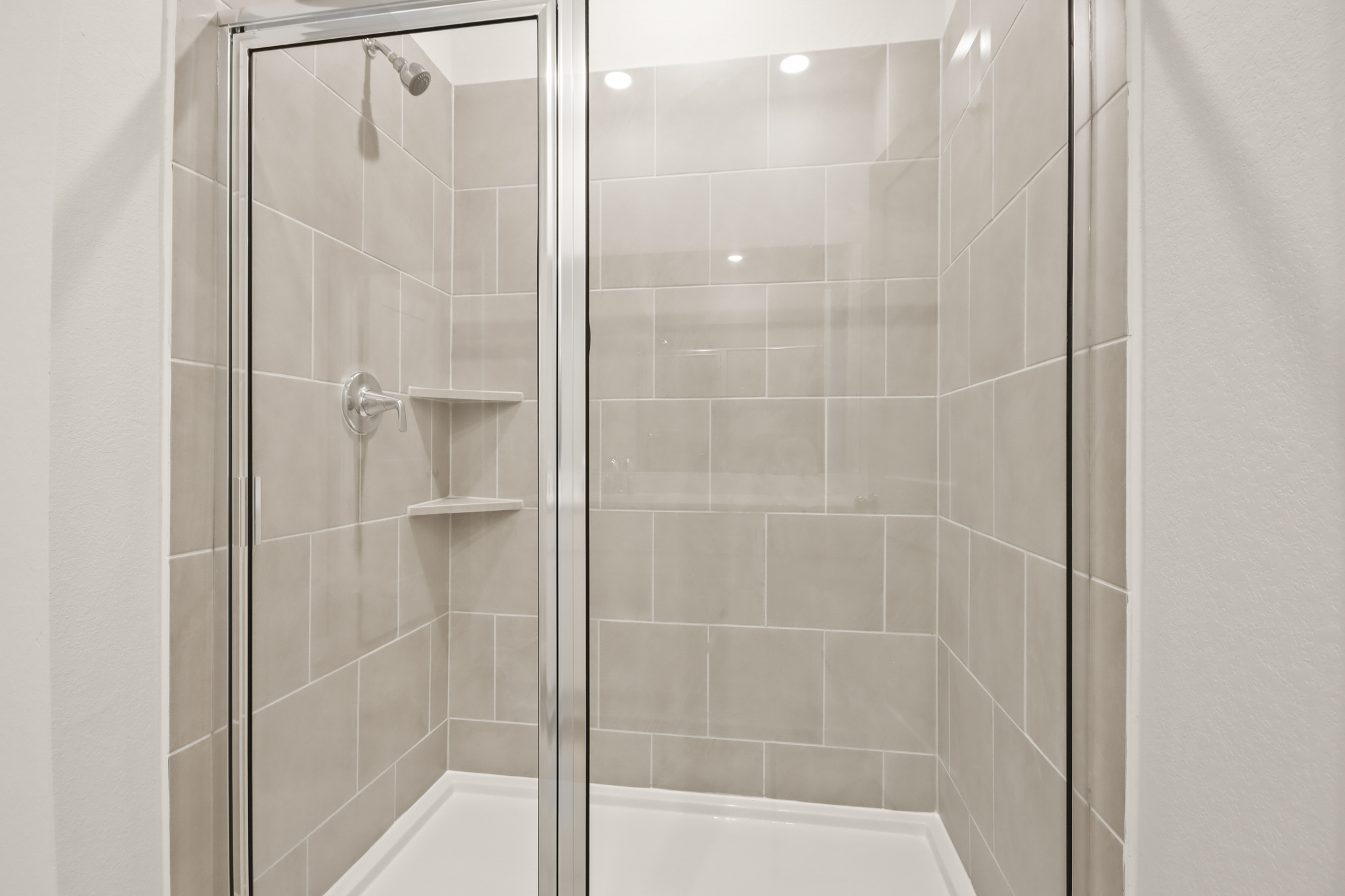 A shower with a glass door.