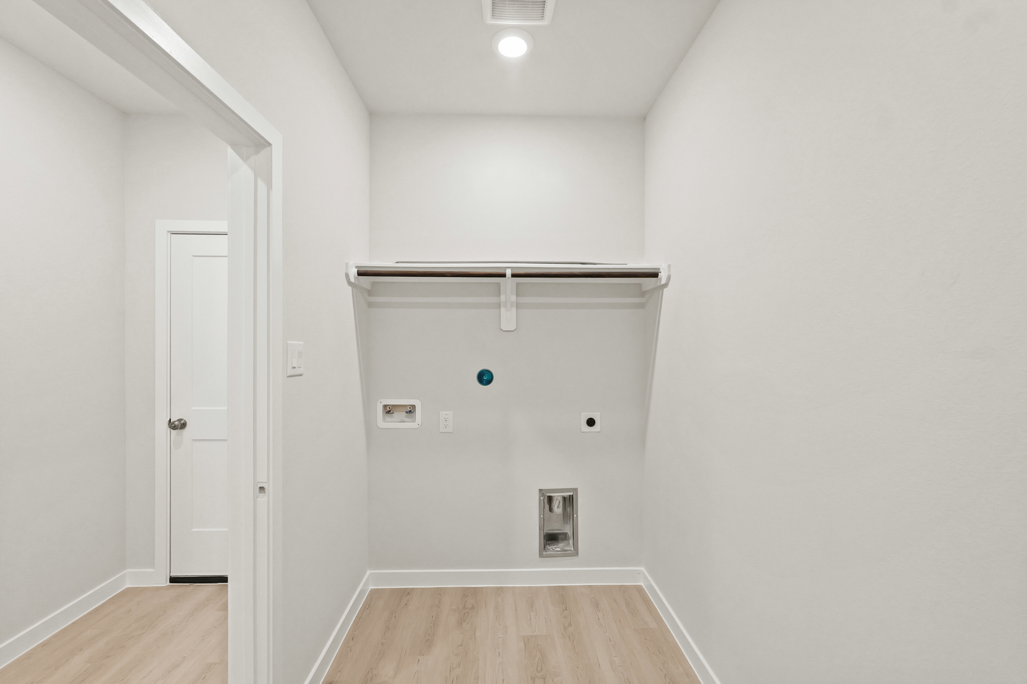 A room with a wood floor and white walls.