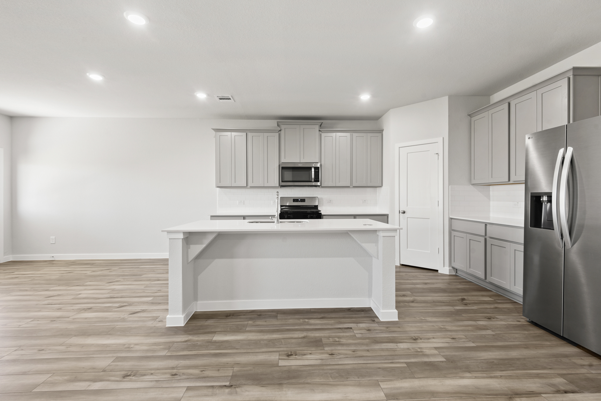 A kitchen with white cabinets.