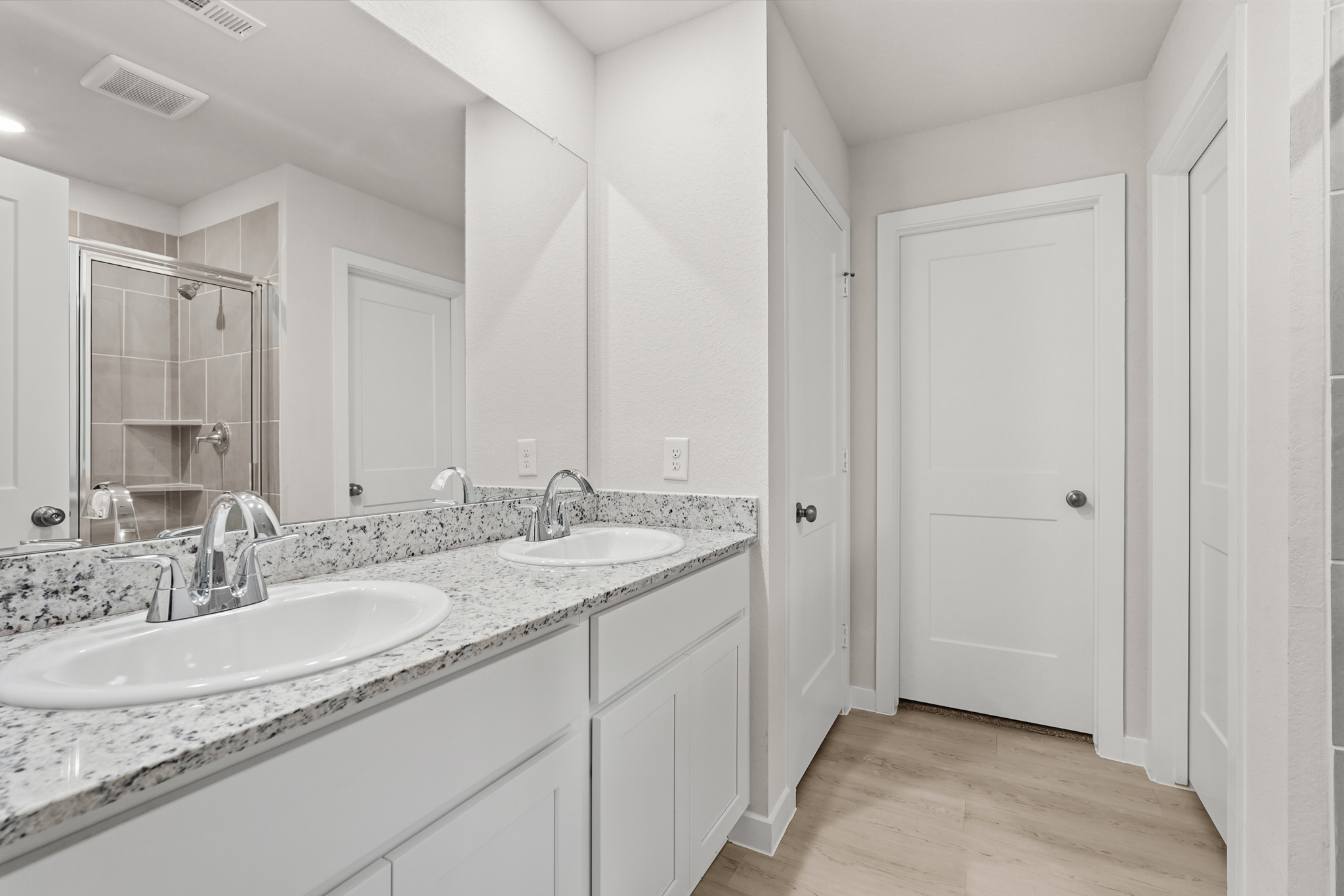 A bathroom with a large mirror.