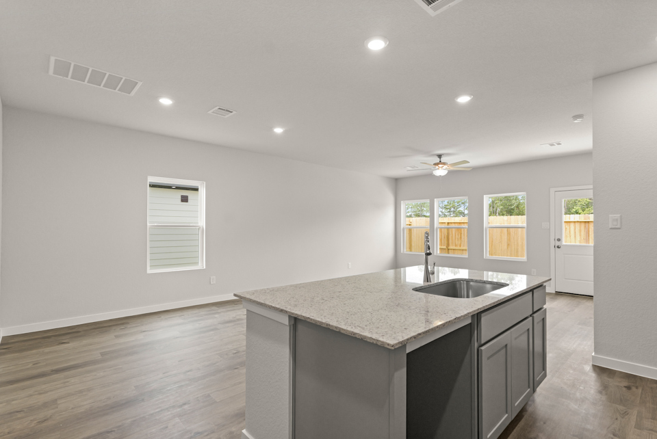 A kitchen with a marble countertop.