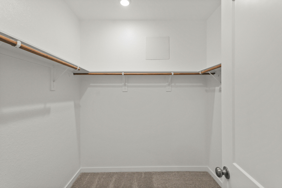 A white room with a metal bar.