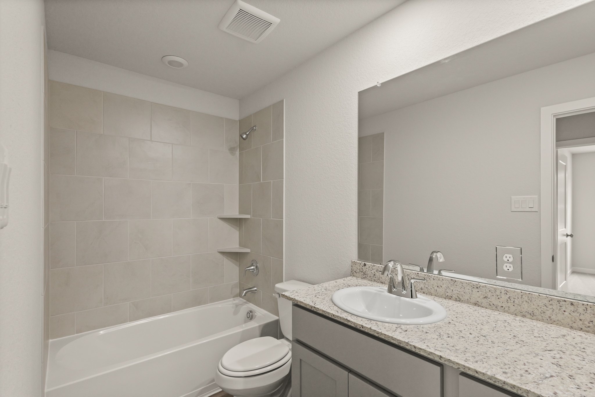 A bathroom with a marble countertop.