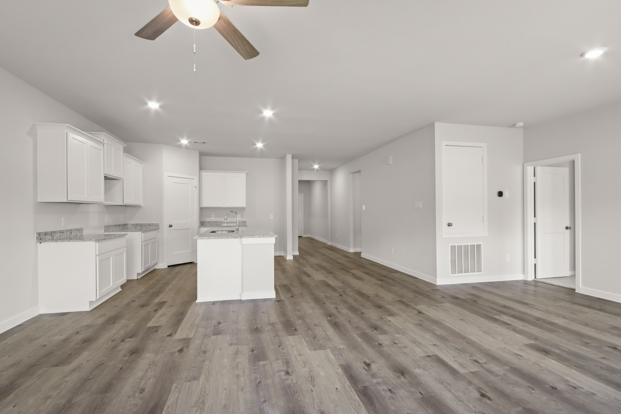 A large kitchen with white cabinets.