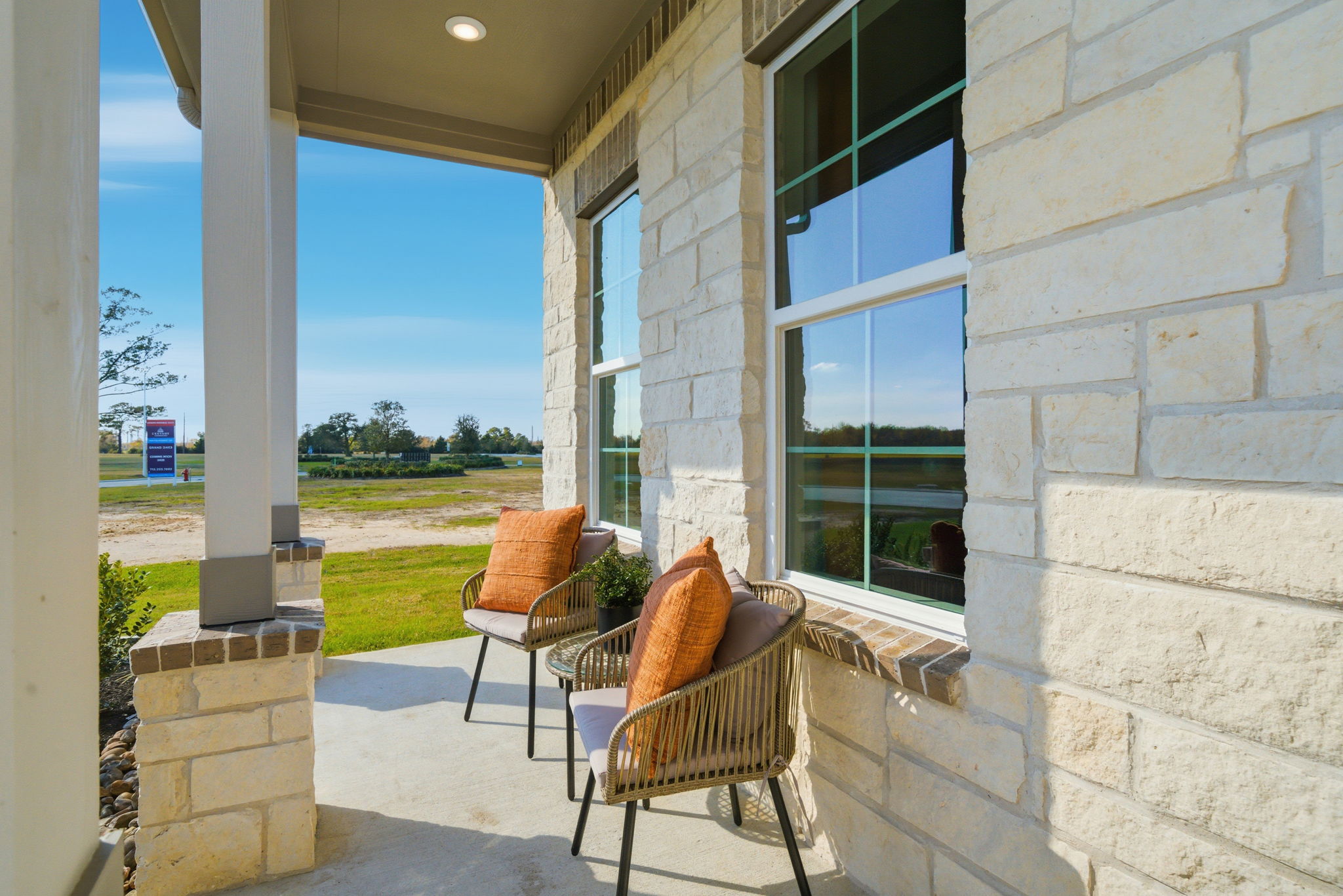 A patio with chairs and a table.