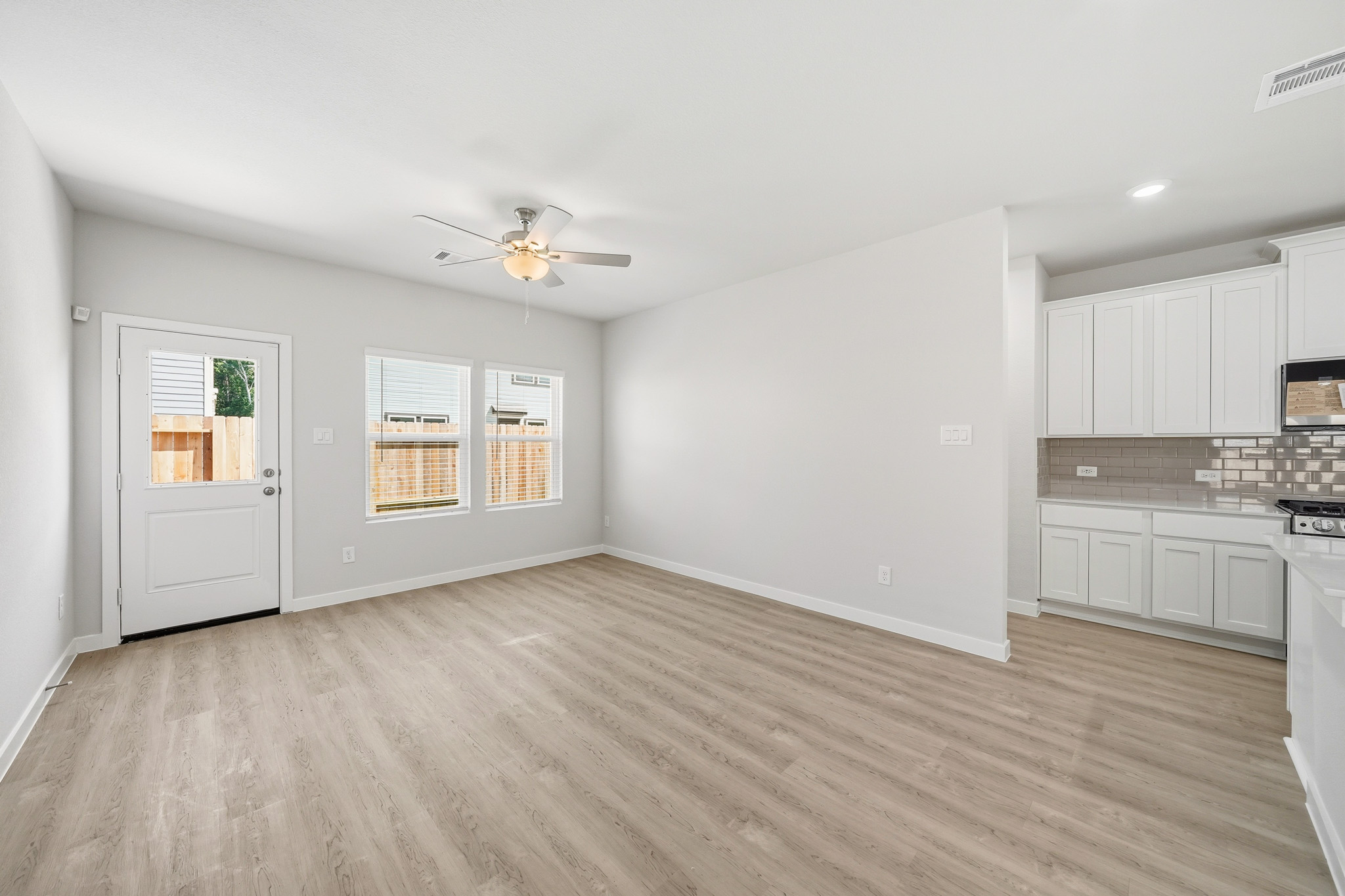 A kitchen with white cabinets.