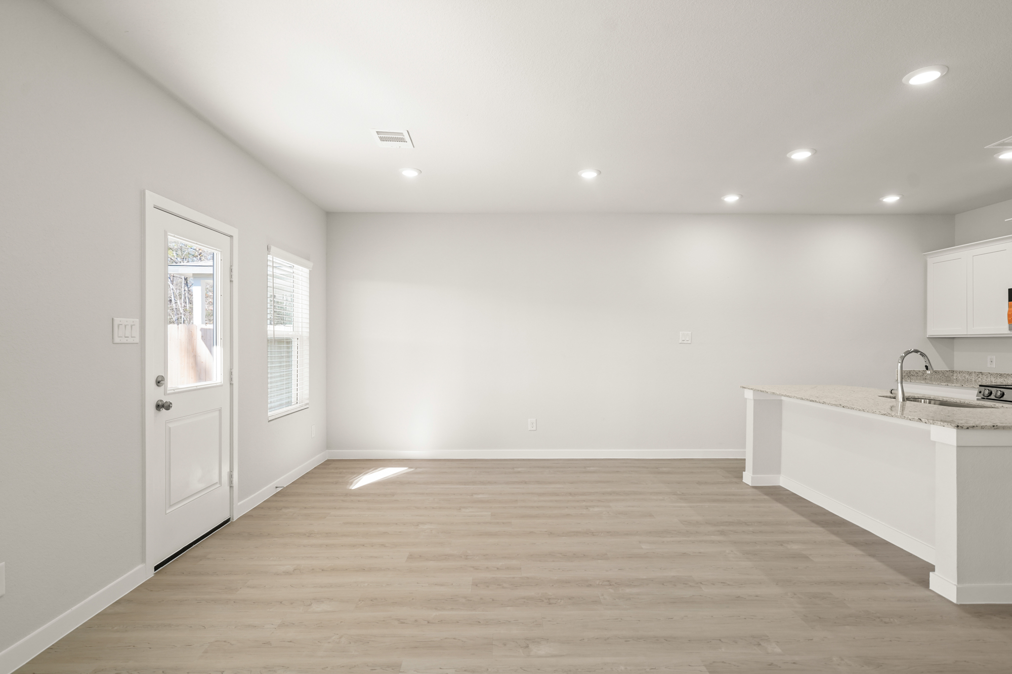 A kitchen with white cabinets.