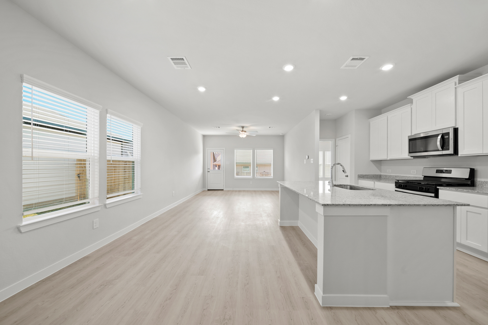 A kitchen with white cabinets.