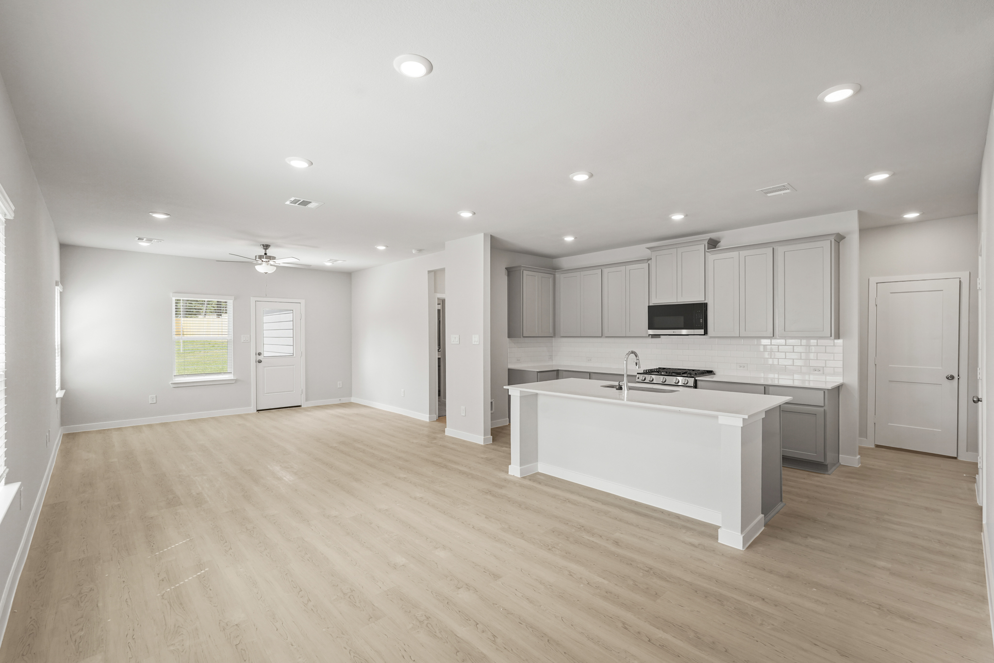 A large kitchen with white cabinets.