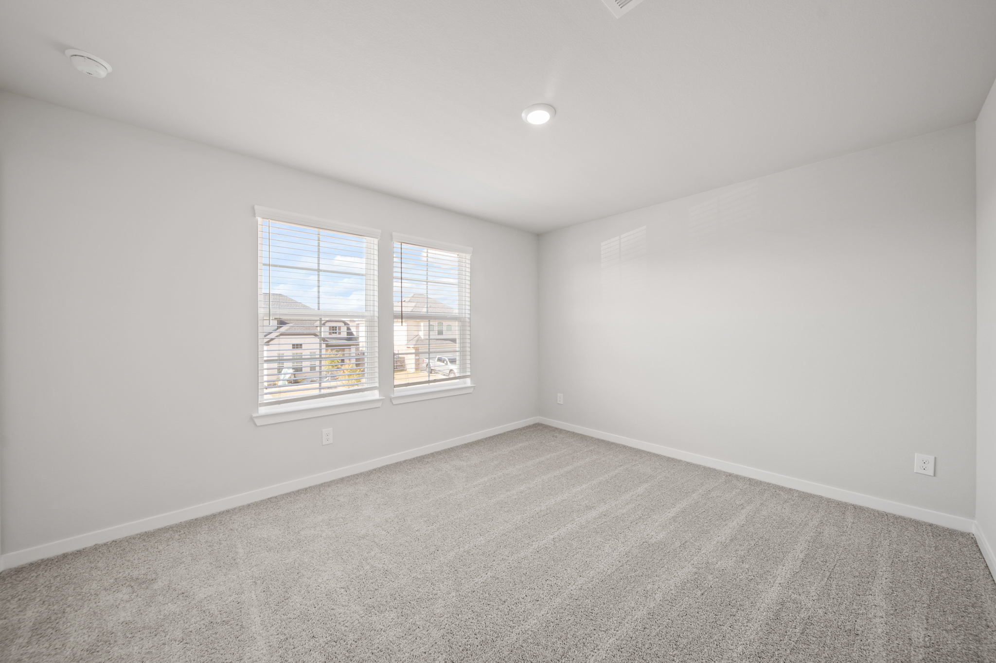 A room with a window and a carpet.