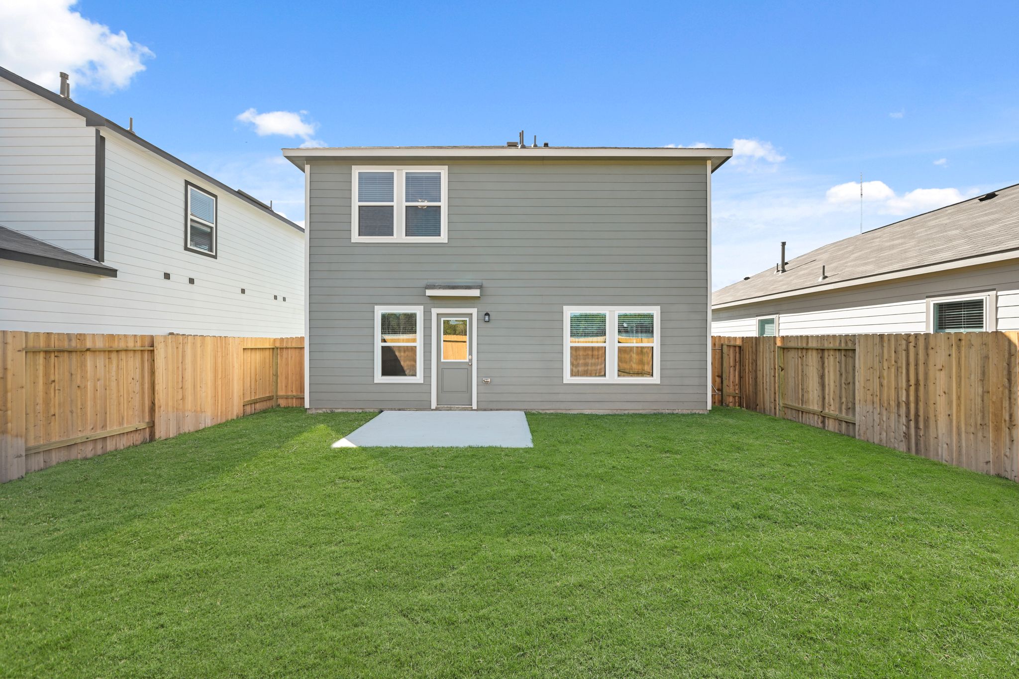 A house with a fence and grass.