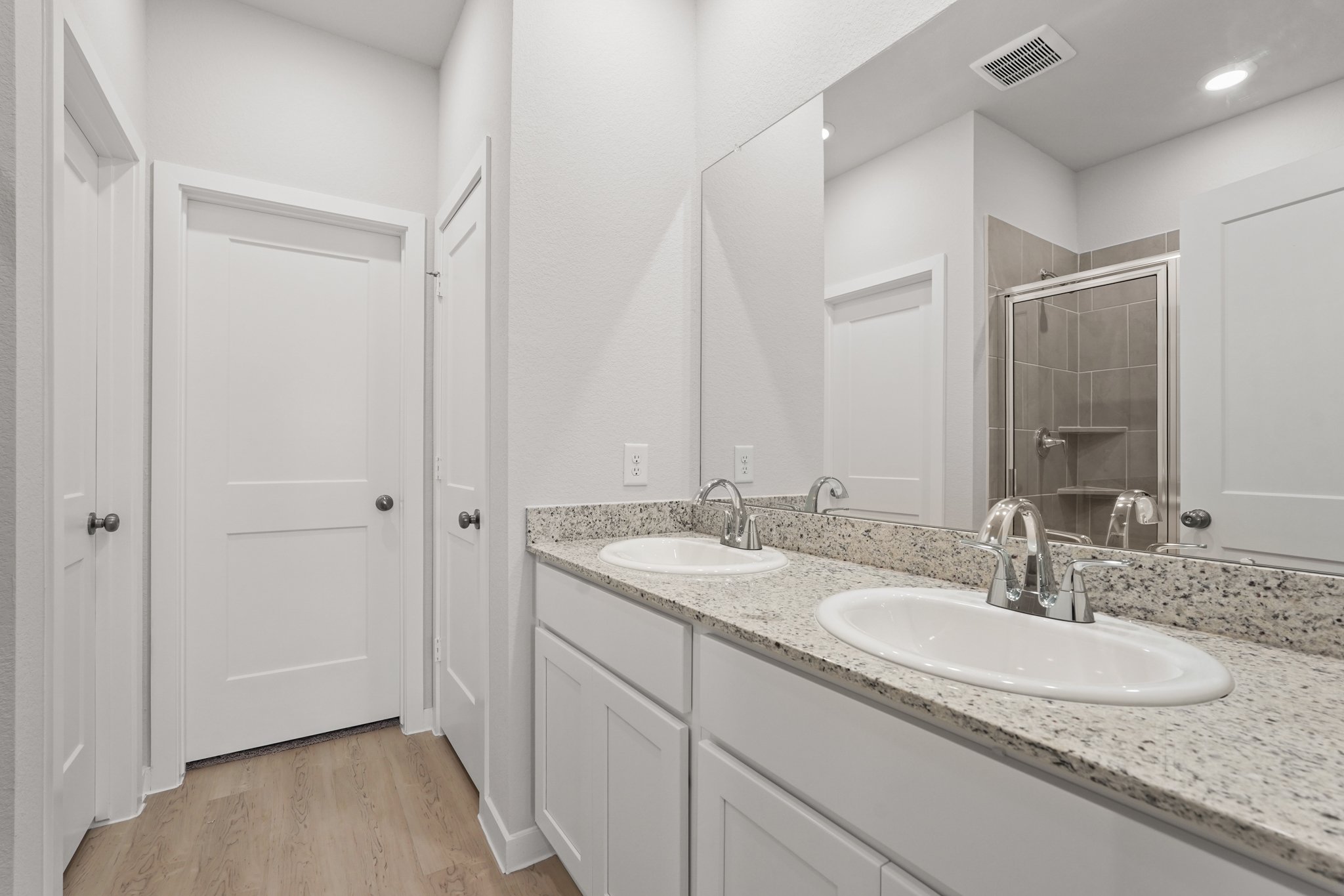 A bathroom with a large mirror.