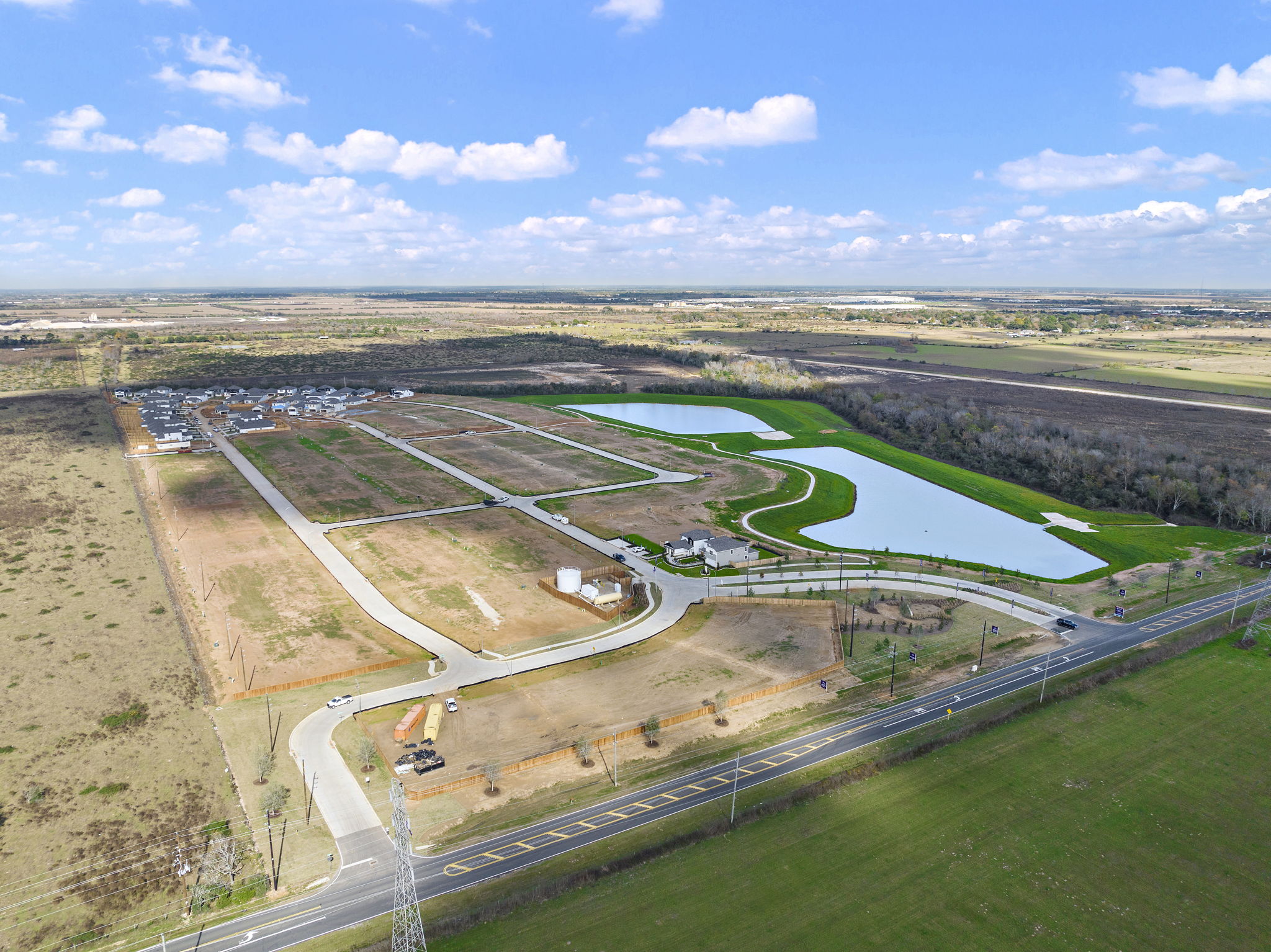A high angle view of a road with Prairie Queen Recreation Area in the background.