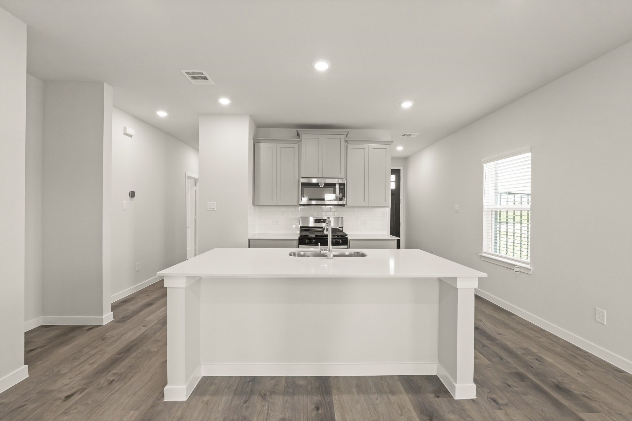 A kitchen with a white counter top.