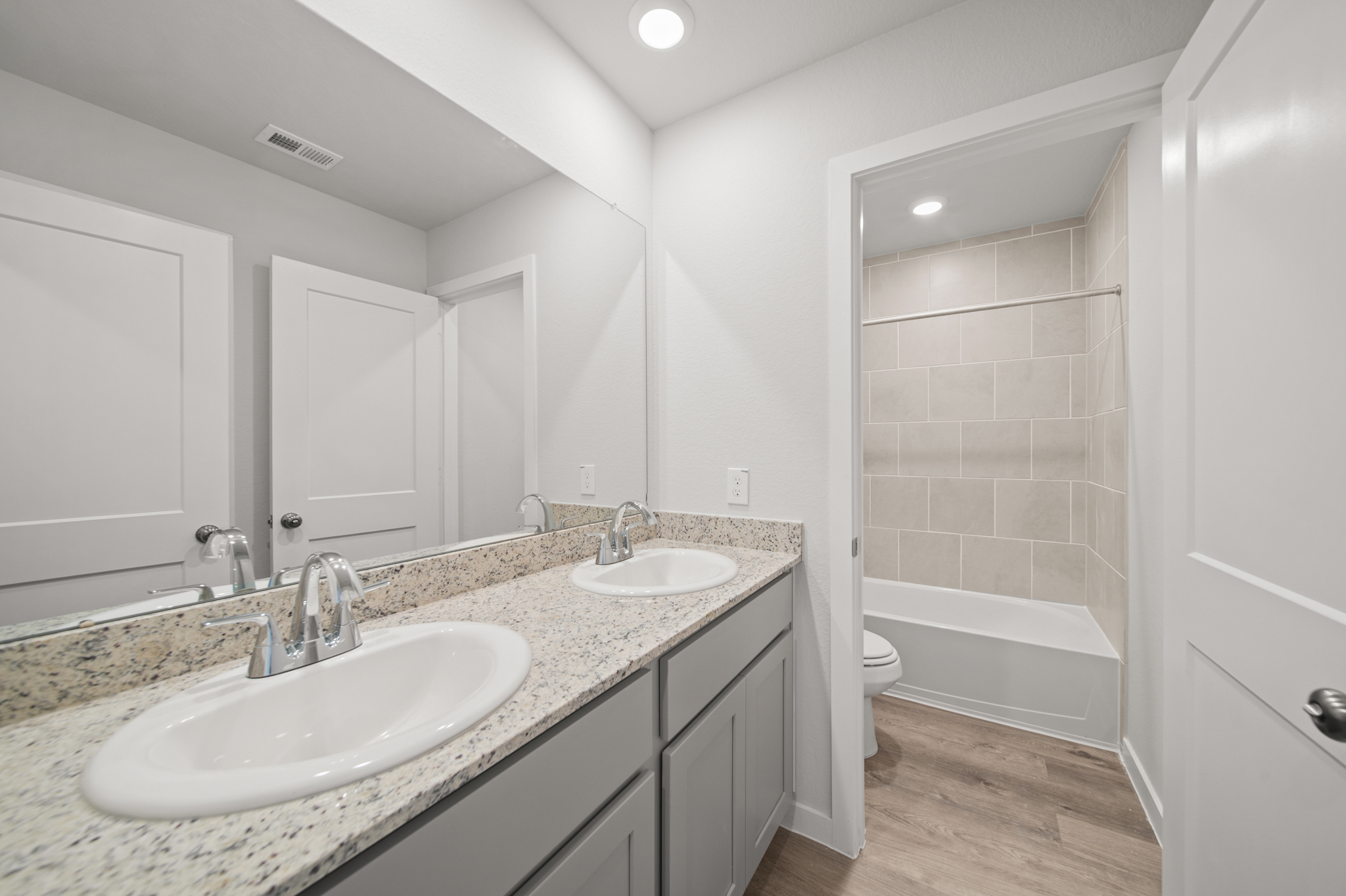 A bathroom with a marble countertop.