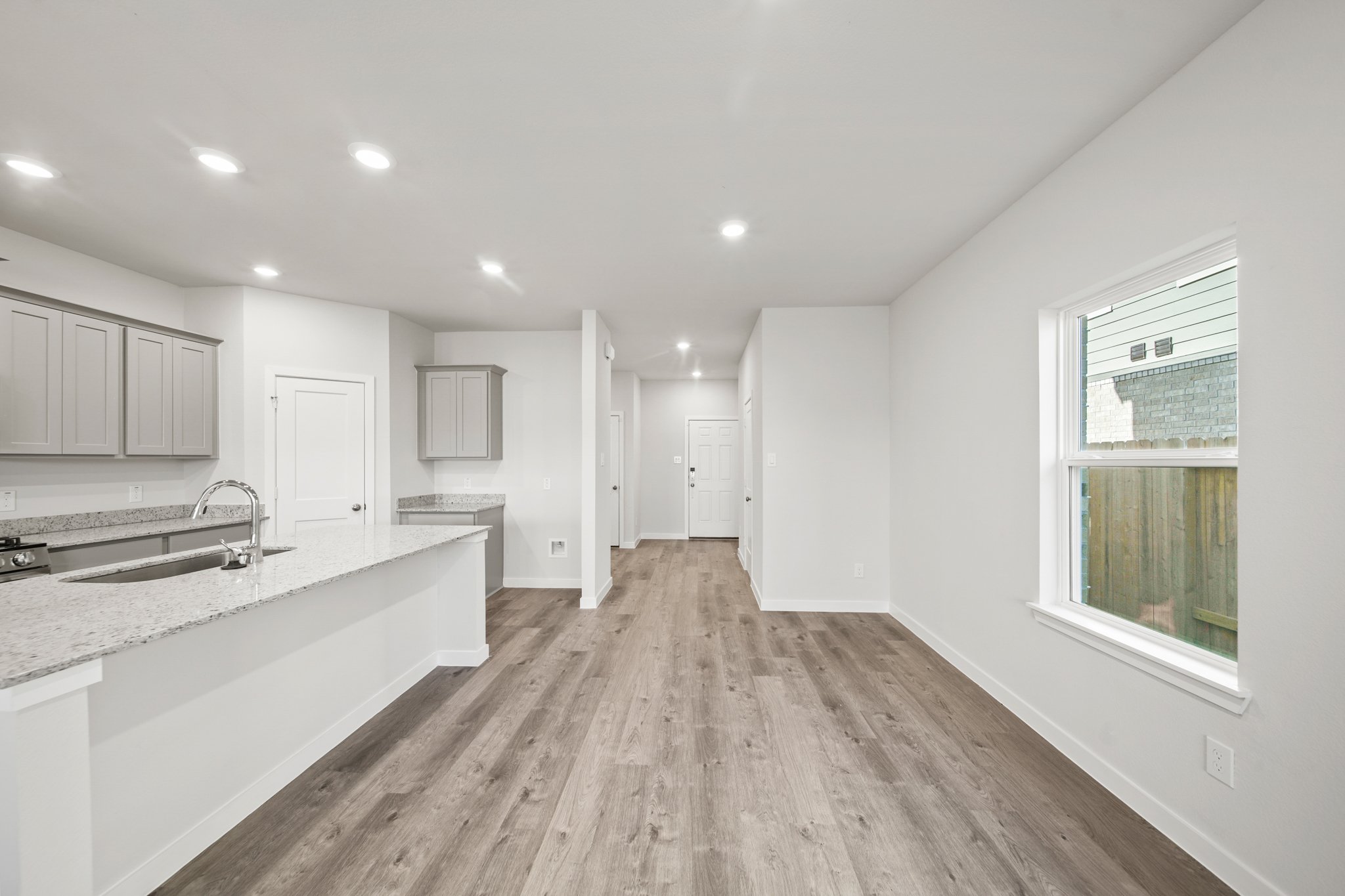 A large kitchen with white cabinets.