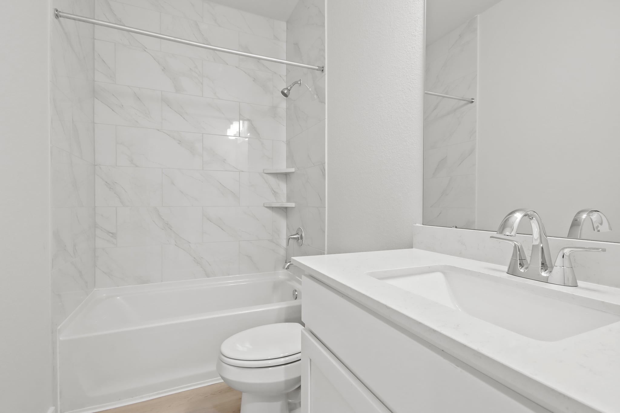 A bathroom with a shower and sink.