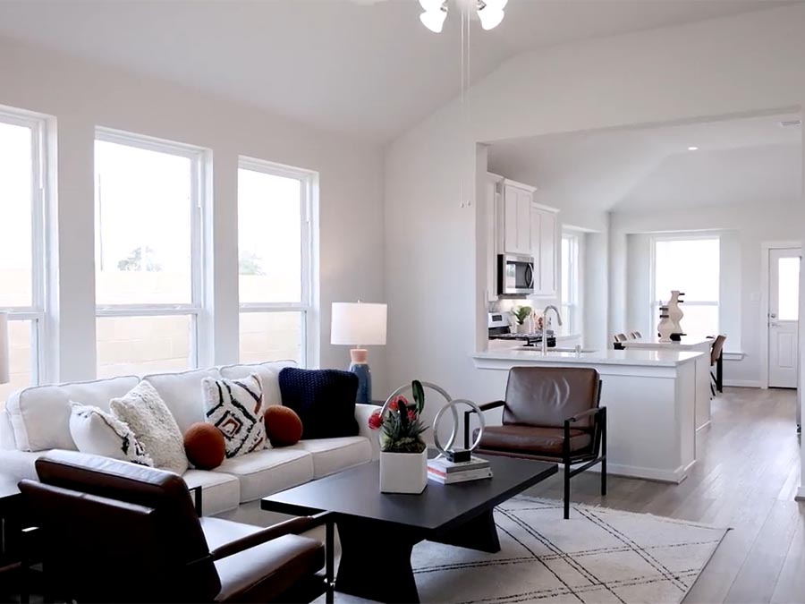 A living room with a white couch and a table.