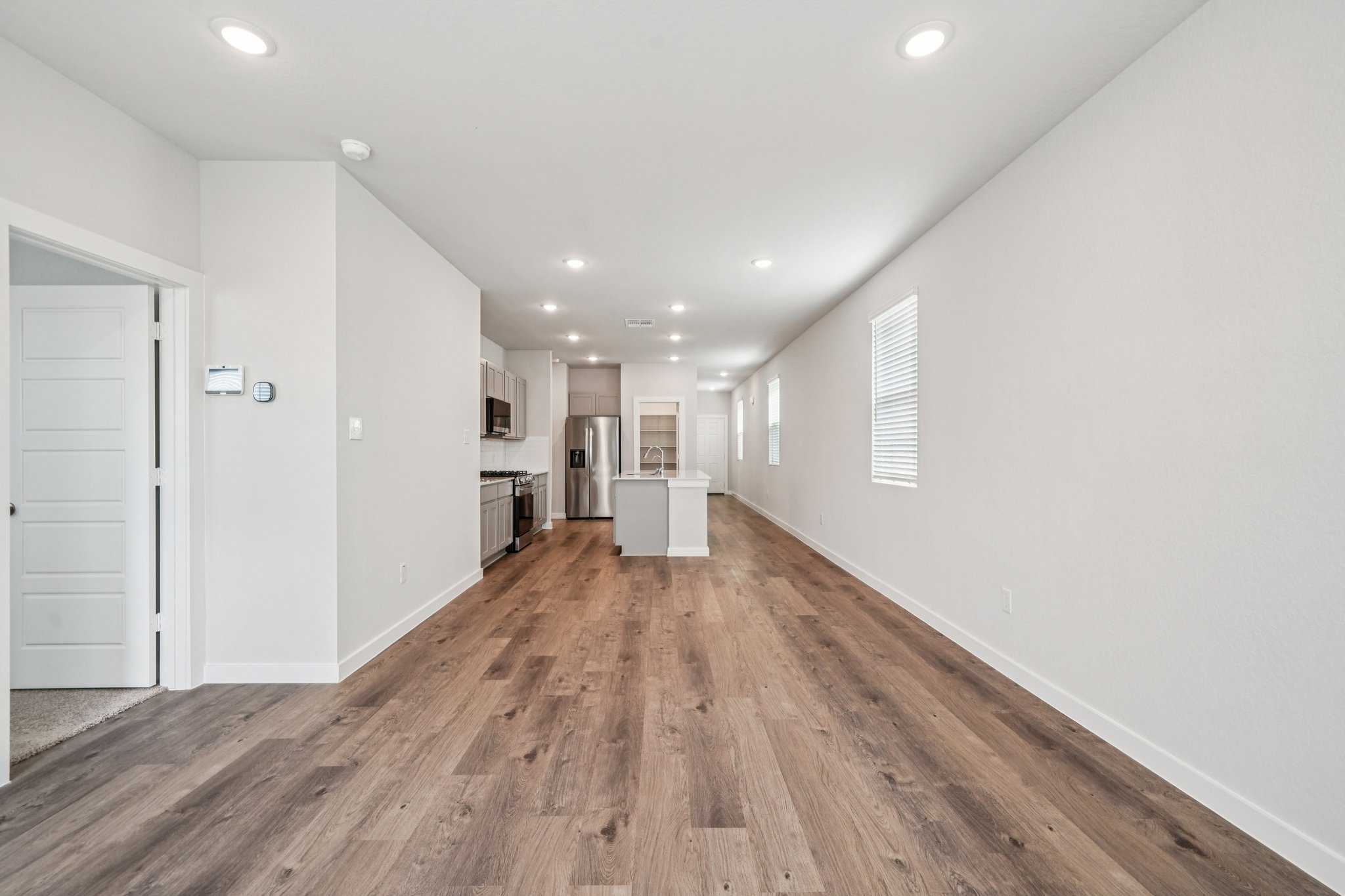 A long hallway with white walls.