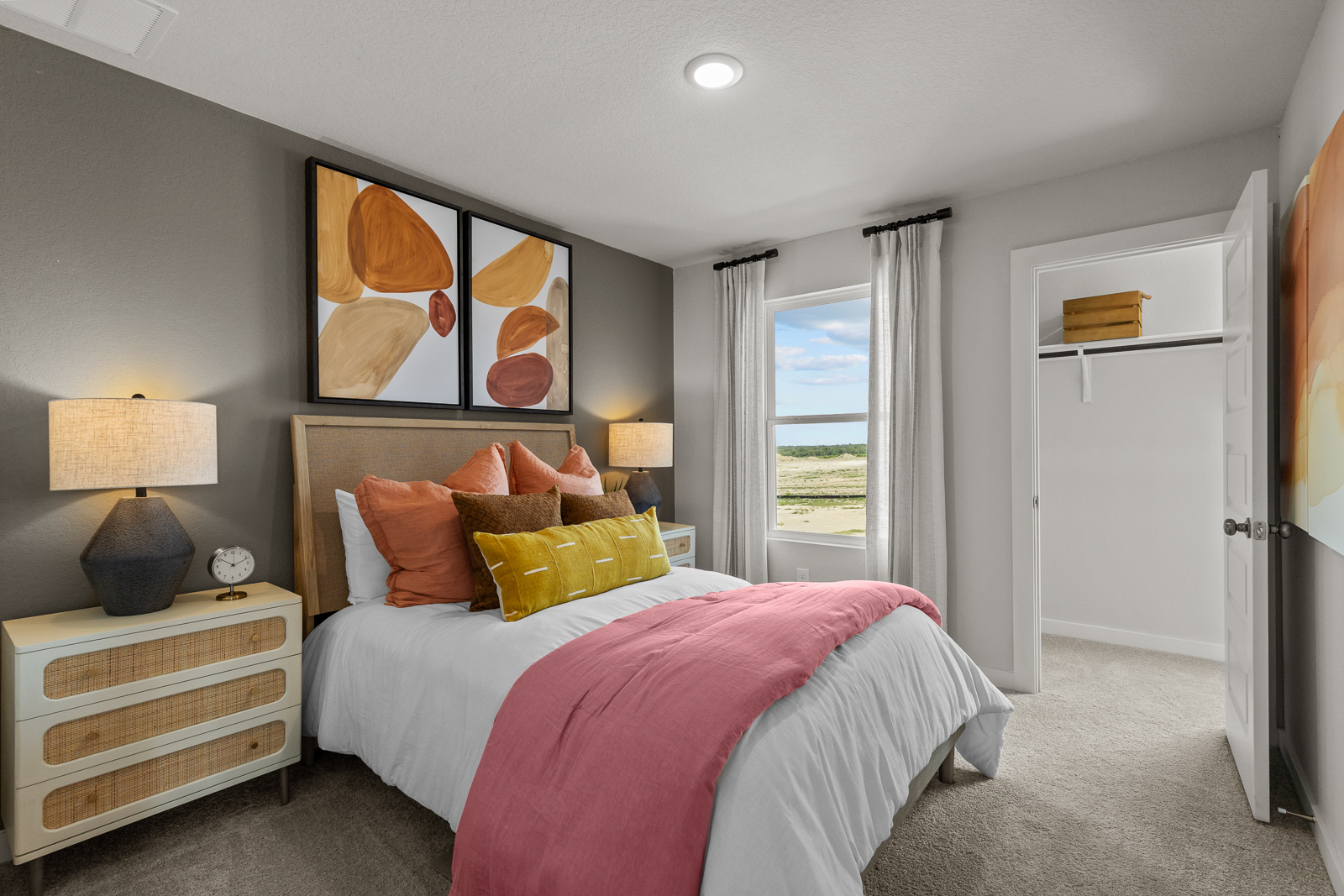 A bedroom with a bed and a lamp.