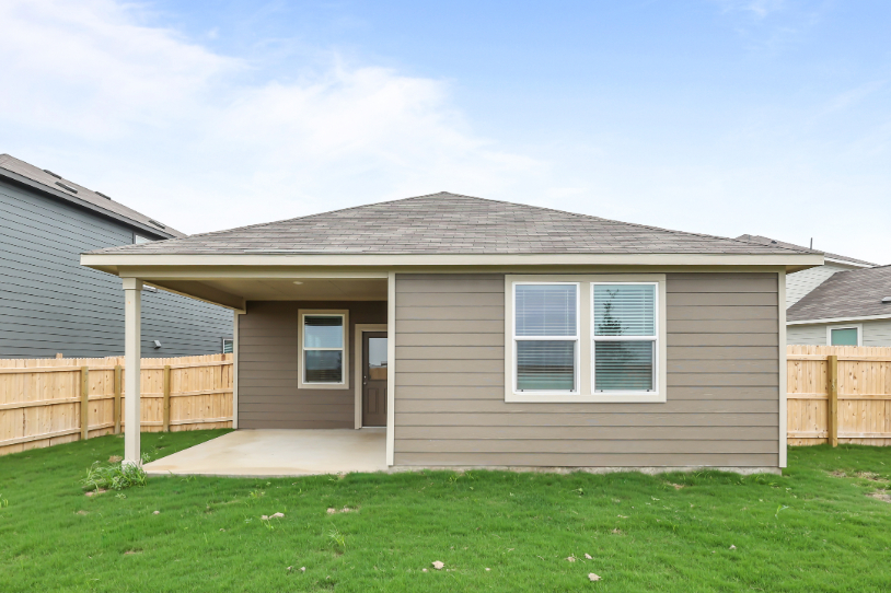 A house with a fence and grass.
