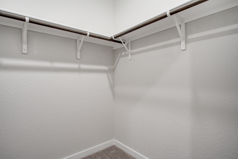 A white wall with a metal railing.