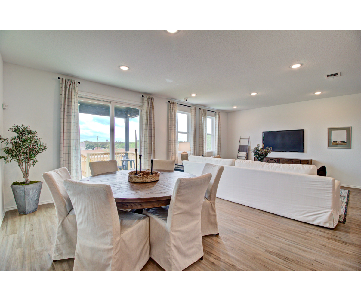 A large room with a bed and a tv.