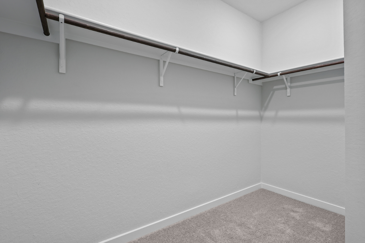 A white wall with a metal railing.