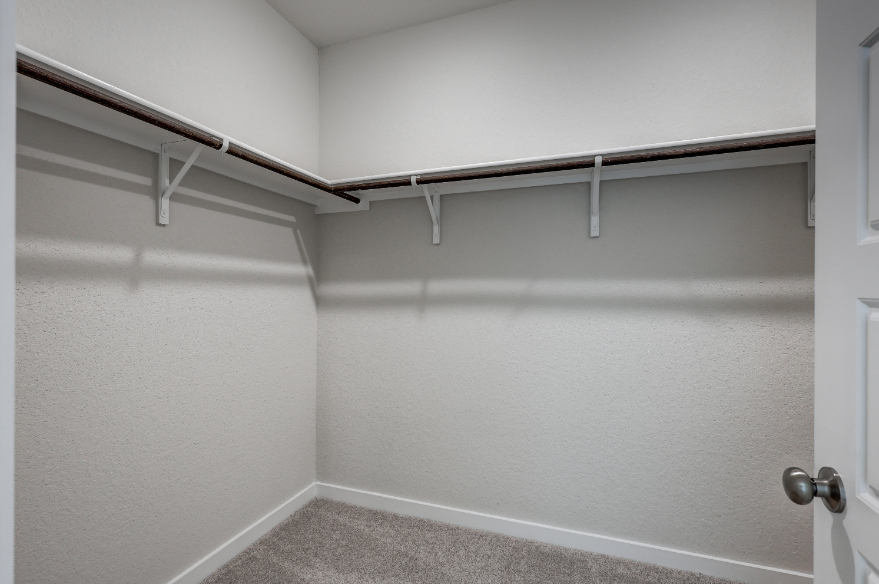 A white wall with a metal railing.