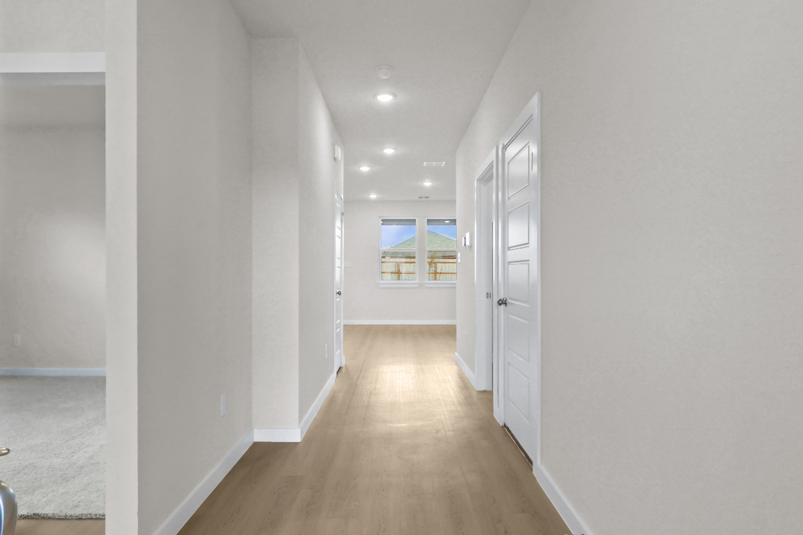 A hallway with white walls.