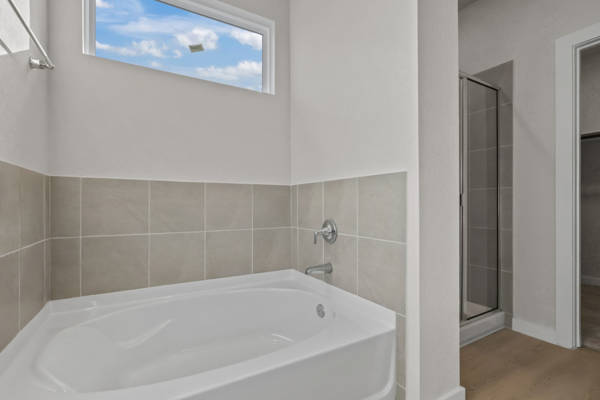 A bathtub in a bathroom.