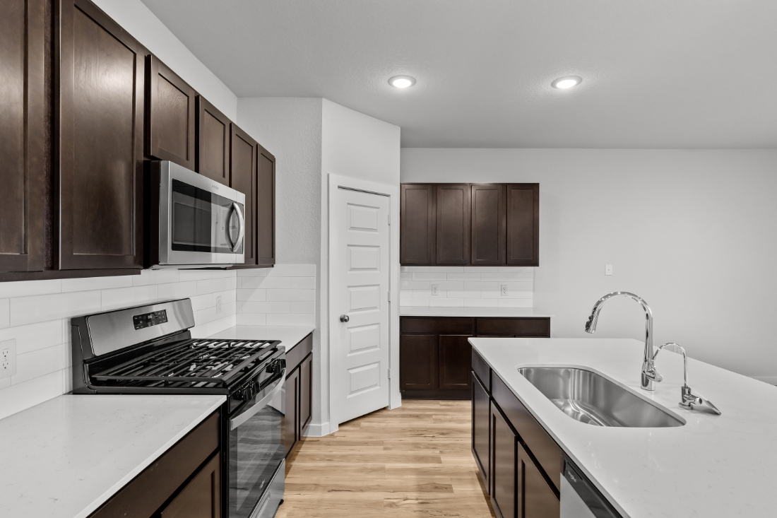 A kitchen with wooden cabinets.