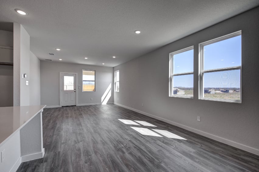 A room with a large window and a large white floor.