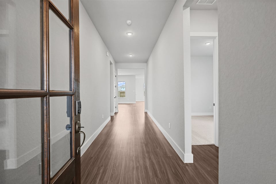 A hallway with glass doors.