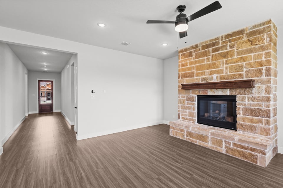 A room with a fireplace and a brick wall.