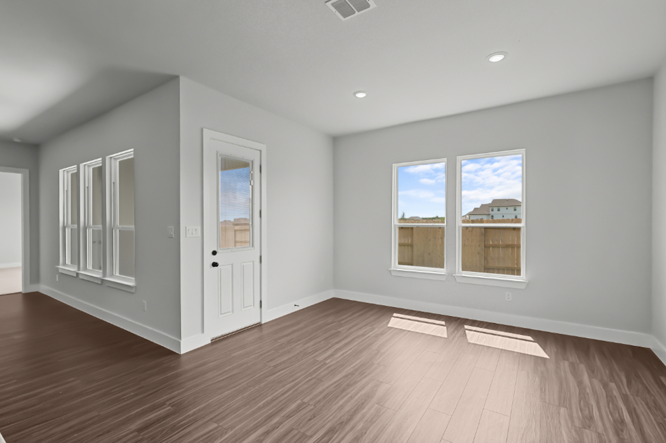 A room with white walls and a wood floor.