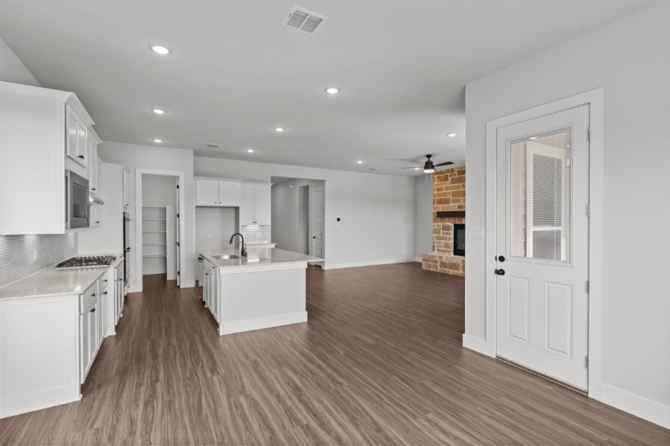 A kitchen with white cabinets.