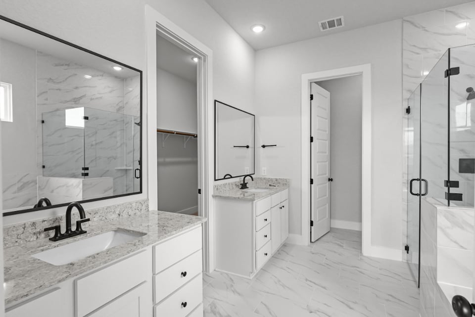 A bathroom with a large mirror.