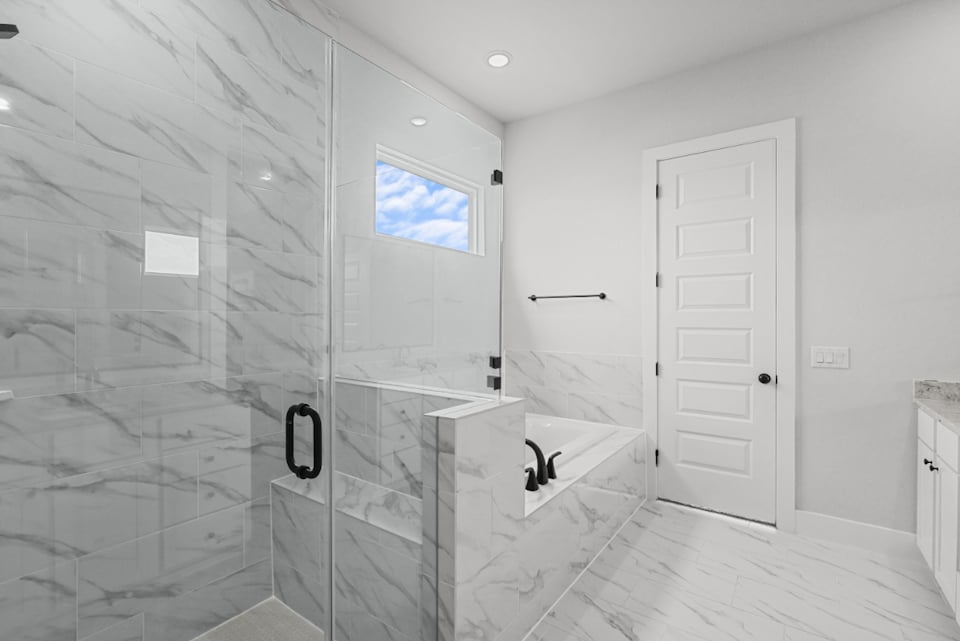 A bathroom with a glass shower.