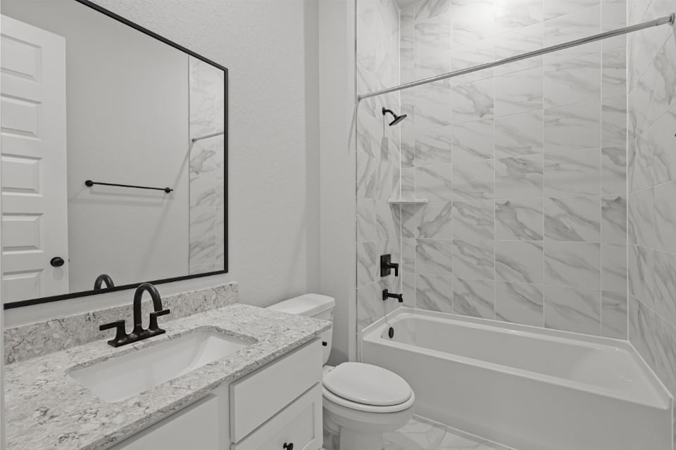 A bathroom with a shower and sink.