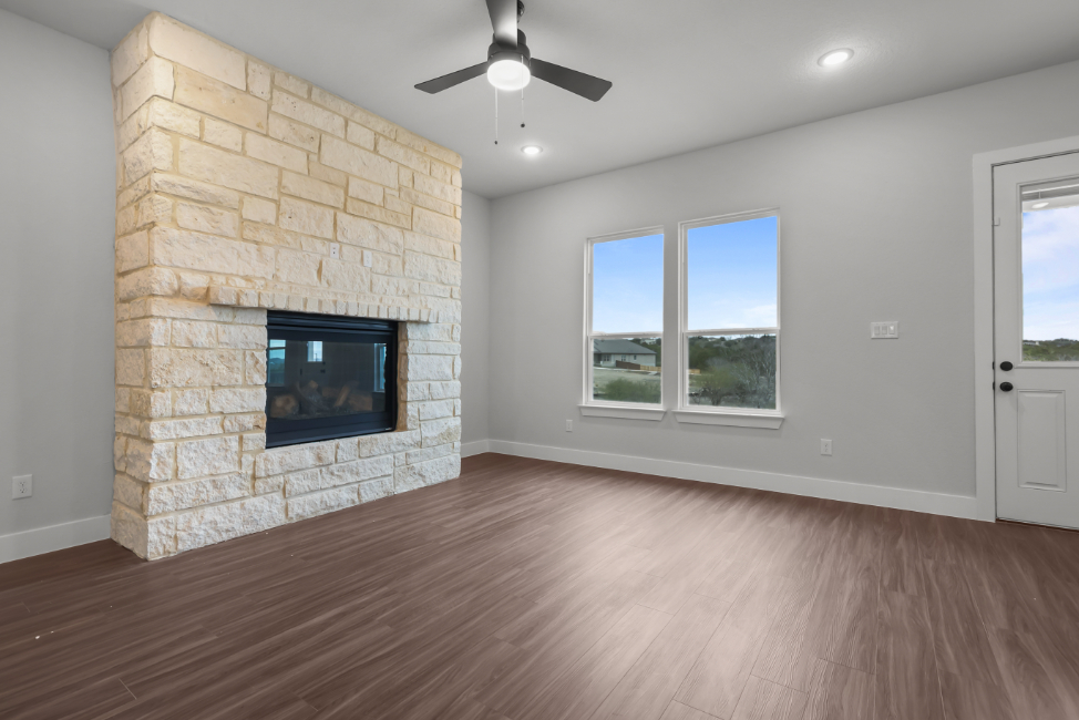 A room with a fireplace and a wood floor.