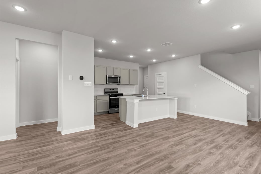 A kitchen with white cabinets.